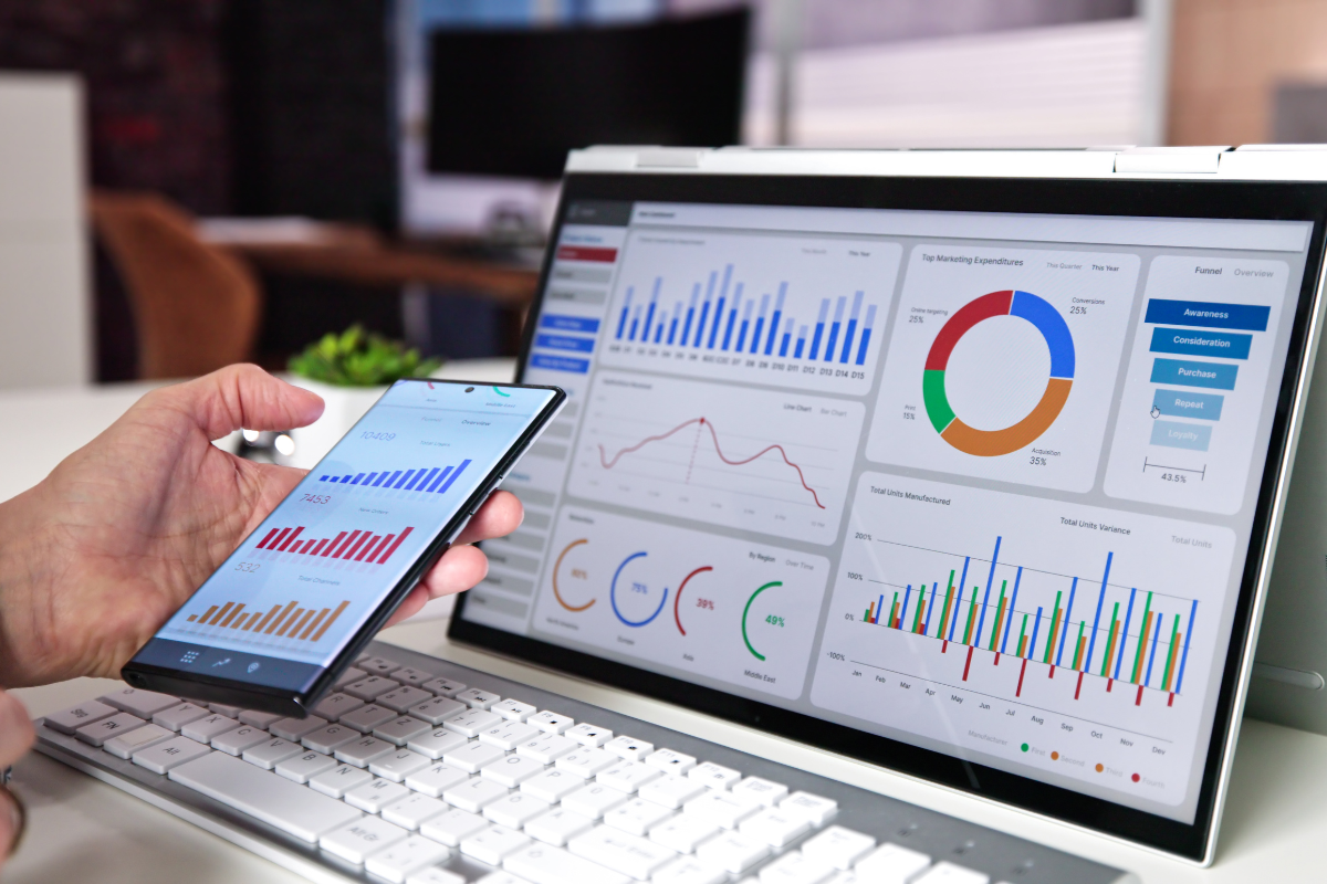 Google Analytics 4 (GA4) dashboard on a laptop and tablet displaying data insights for public sector and non-profits.